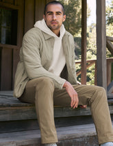 brown men's button up insulated jacket with a shirt collar and side seam invisible zipper pockets.